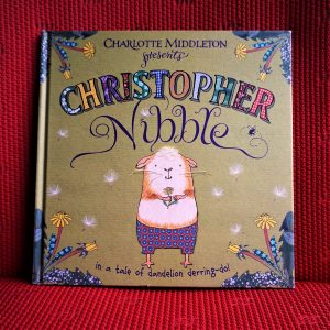Christopher Nibble: a picture book. A guinea book stands on the cover.